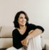woman in black long sleeve shirt sitting on white couch
